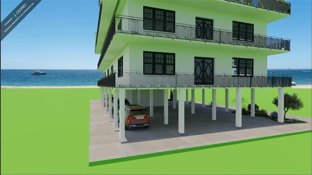 exterior space featuring a carport, a water view, and a view of the beach