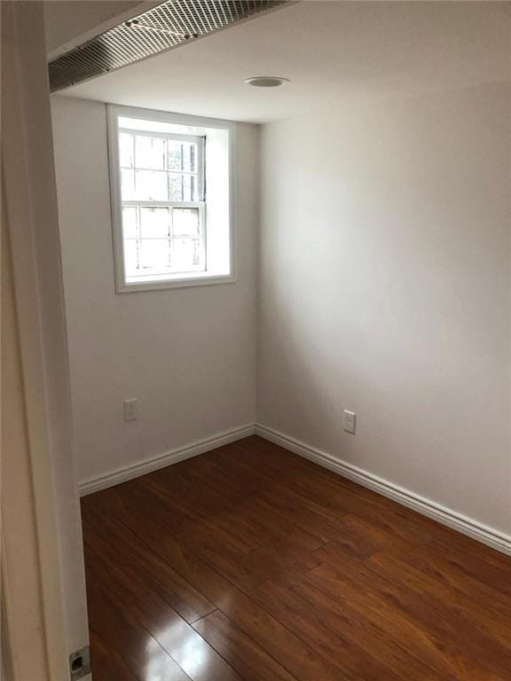 spare room featuring dark wood-type flooring