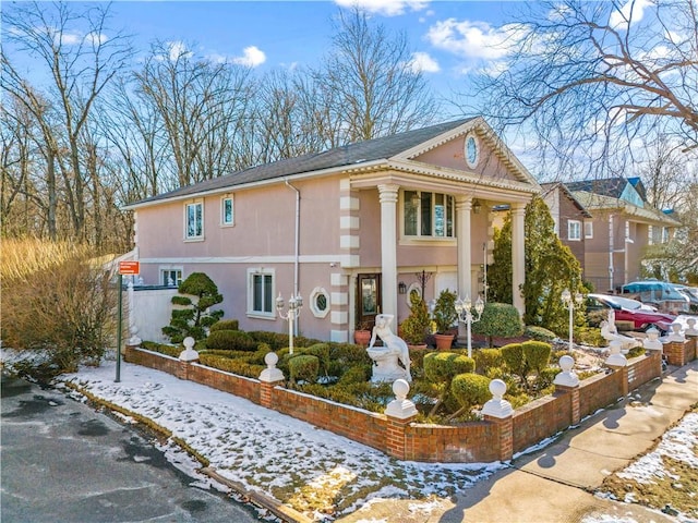 view of snow covered exterior featuring stucco siding