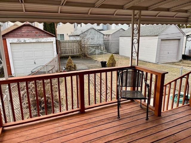 deck with fence and an outdoor structure