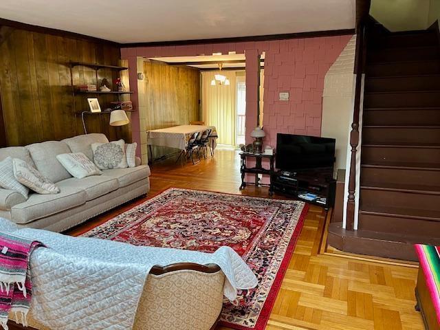 2156 Kimball St, Brooklyn, NY 11234 - living room featuring stairway and wooden walls