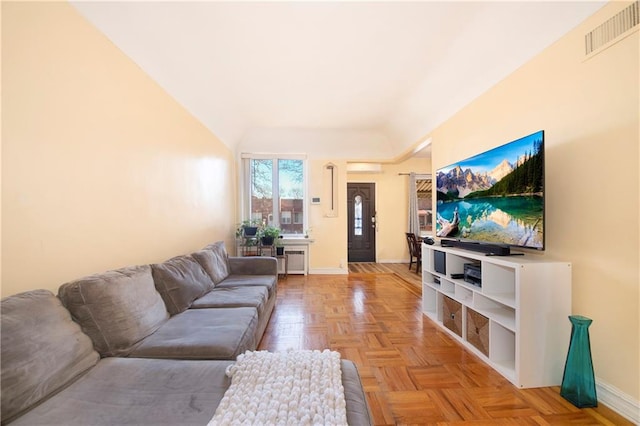 living area with radiator, visible vents, and baseboards