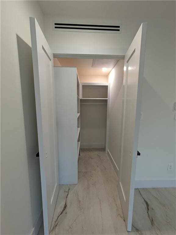 walk in closet featuring a wall mounted air conditioner