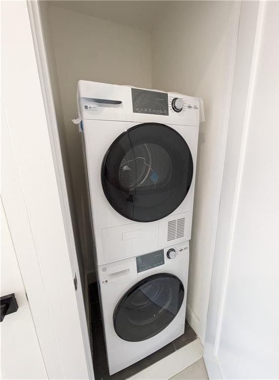 122 Palmetto St Unit 3L, Brooklyn, NY 11221 - laundry room featuring stacked washer / dryer and tile patterned floors