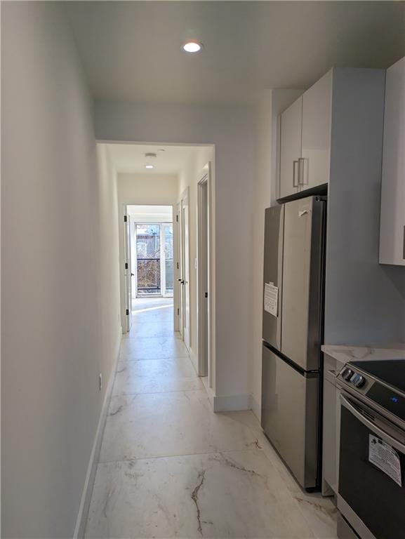 interior space featuring appliances with stainless steel finishes and white cabinets