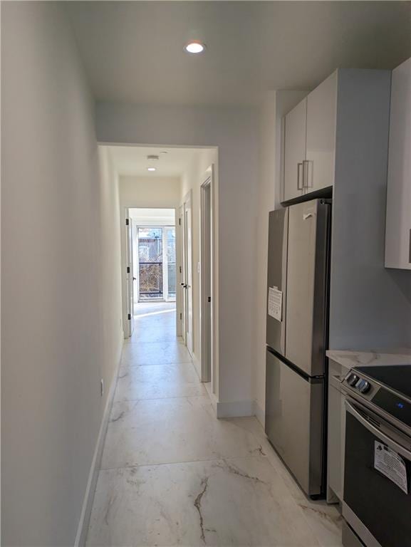 122 Palmetto St Unit 3L, Brooklyn, NY 11221 - kitchen with stainless steel appliances, baseboards, white cabinets, light countertops, and recessed lighting