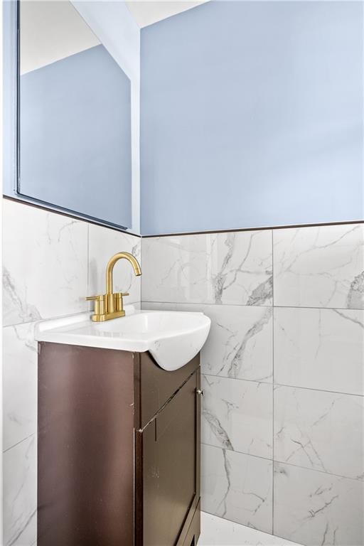 bathroom featuring tile walls and vanity