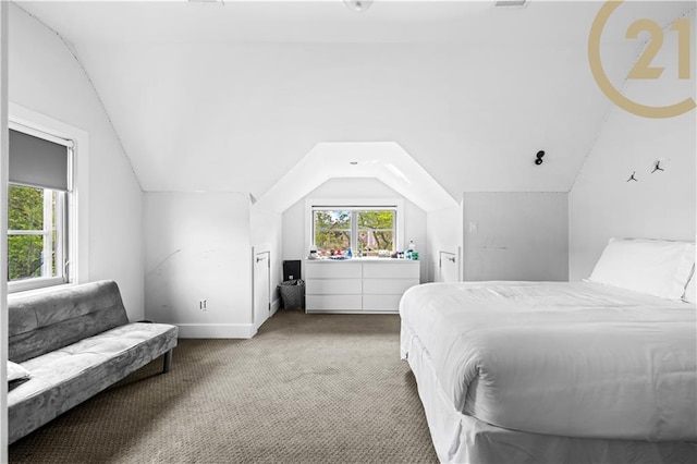 bedroom featuring lofted ceiling, carpet, and baseboards