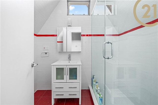 full bath featuring lofted ceiling, a shower stall, tile walls, and vanity