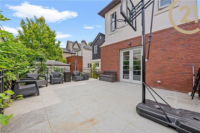 view of patio featuring fence and french doors