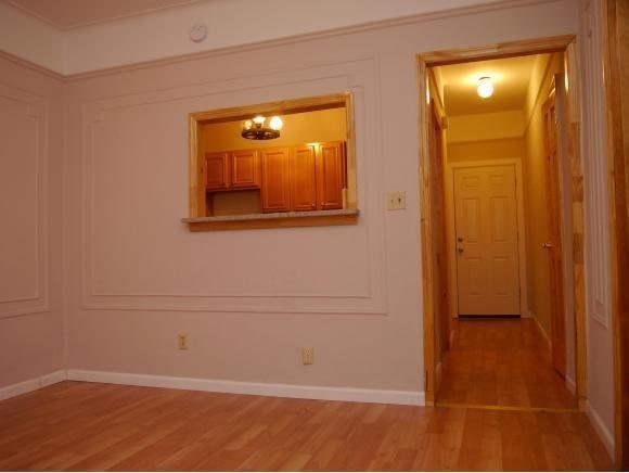 hallway with hardwood / wood-style floors