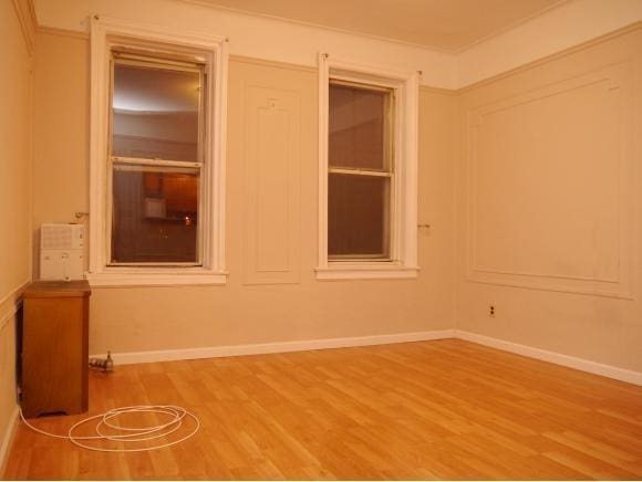 spare room with hardwood / wood-style floors