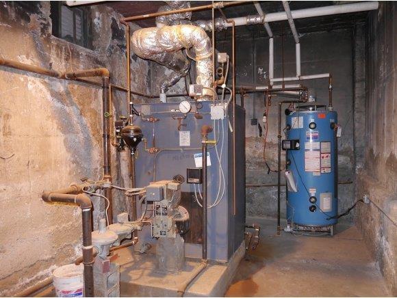 utility room featuring water heater