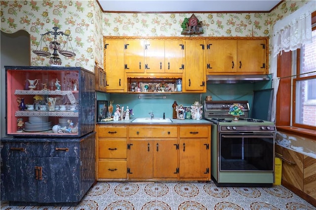 kitchen featuring wallpapered walls, ventilation hood, range, and a sink