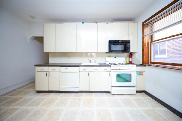 kitchen featuring white appliances, sink, and white cabinets