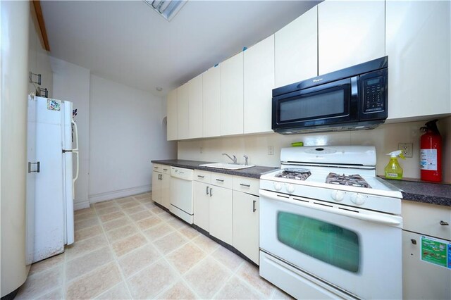 kitchen with sink, white cabinets, and white appliances