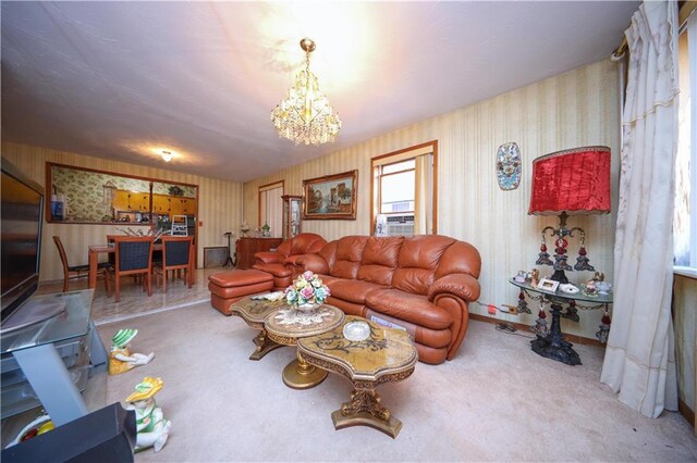 living room with cooling unit and a notable chandelier