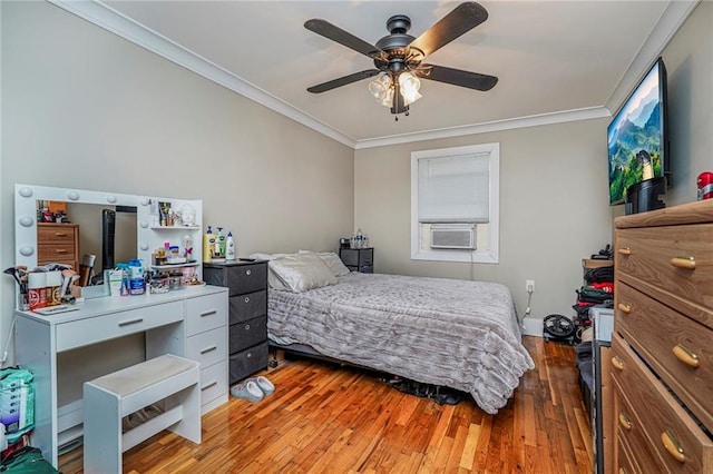 bedroom with crown molding, cooling unit, wood finished floors, and ceiling fan