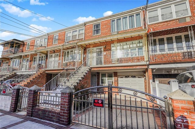 townhome / multi-family property featuring brick siding and a fenced front yard