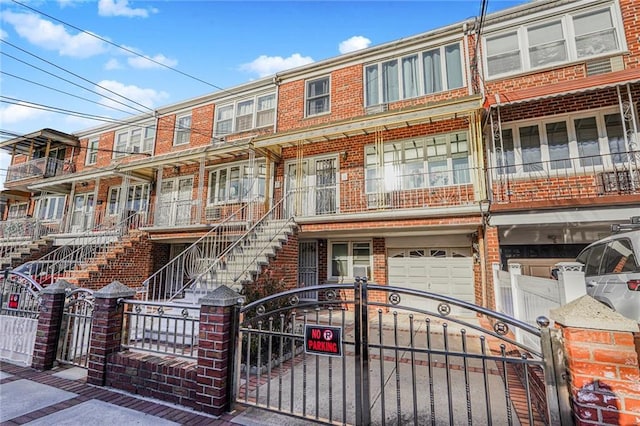 multi unit property featuring brick siding and a fenced front yard