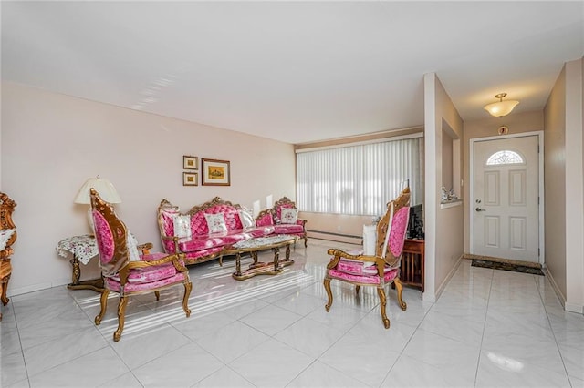 living room featuring a baseboard radiator and baseboards