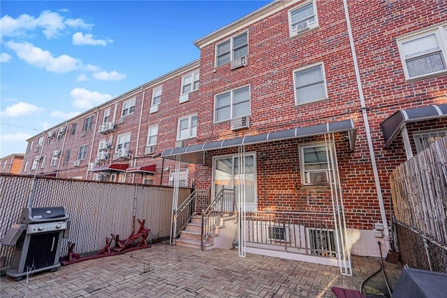 50 Bay 46th St, Brooklyn, NY 11214 - rear view of house with brick siding, a patio, and entry steps