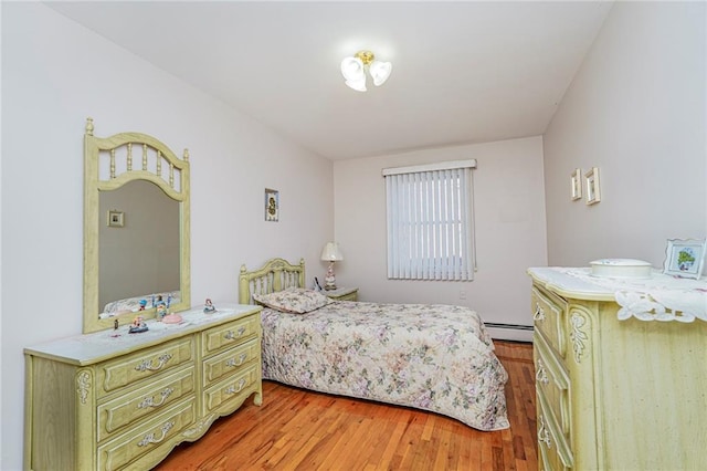 bedroom featuring a baseboard radiator and light wood-style flooring