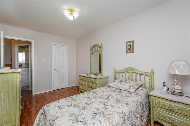 bedroom featuring baseboards and dark wood-style flooring