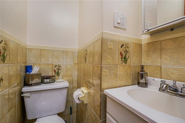 bathroom featuring vanity, tile walls, and toilet