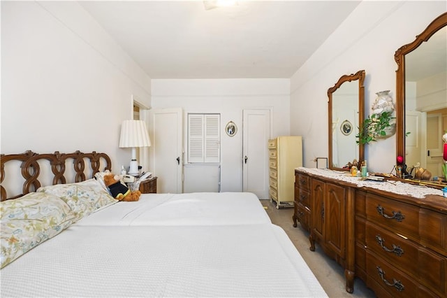 bedroom featuring light colored carpet