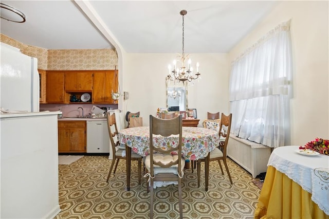 dining area with radiator, a notable chandelier, and sink