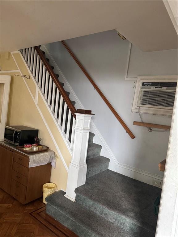 stairway with parquet floors and a wall mounted AC