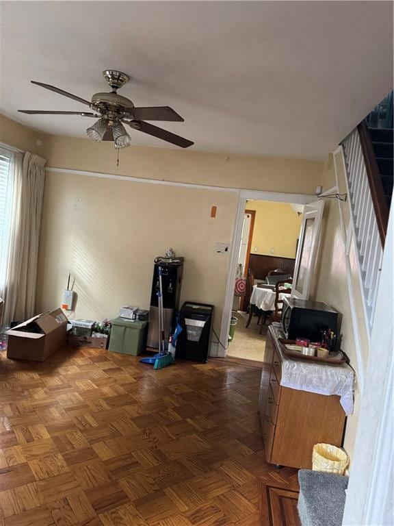 living room featuring parquet flooring and ceiling fan