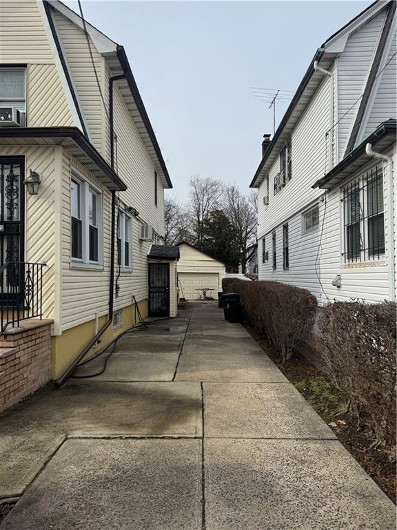 view of side of home featuring an outbuilding and a garage