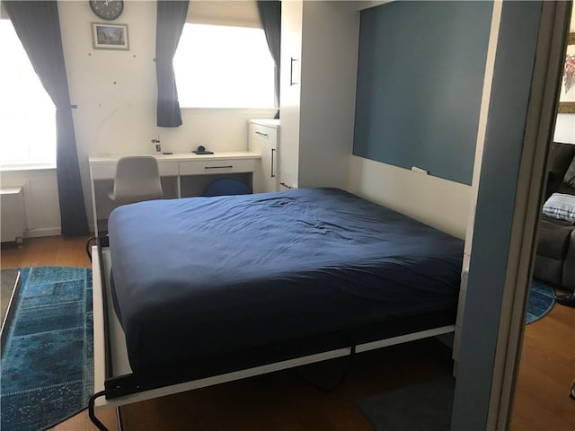 10108 4th Ave Unit 25A, Brooklyn, NY 11209 - bedroom featuring multiple windows and wood finished floors