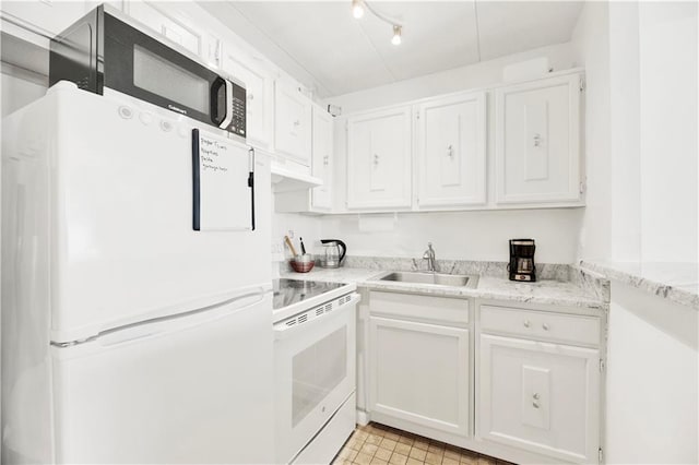 kitchen featuring white appliances, white cabinetry, and a sink