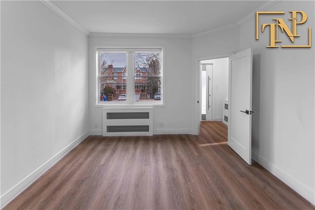 spare room with crown molding and dark wood-type flooring