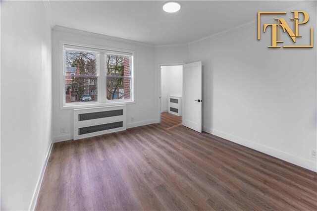 interior space with crown molding, dark hardwood / wood-style floors, and radiator