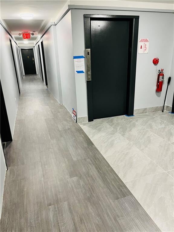 hall featuring elevator and light wood-type flooring