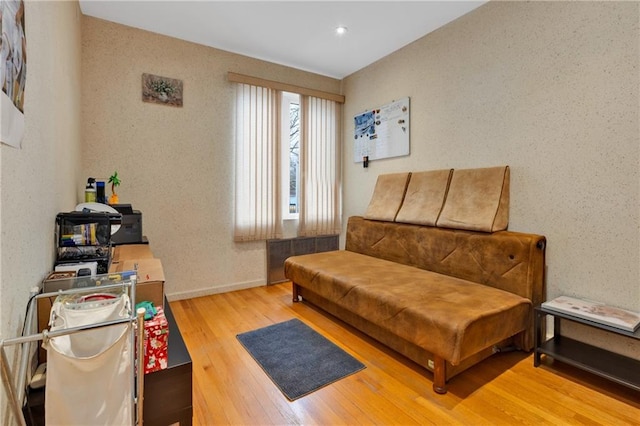 sitting room with baseboards and wood finished floors