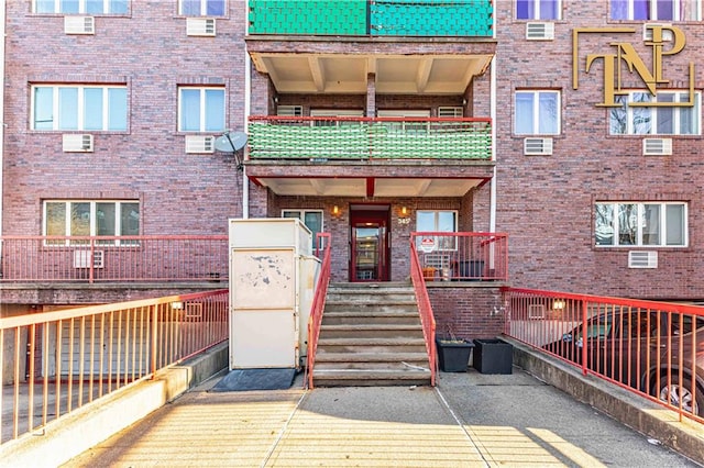 view of exterior entry featuring brick siding