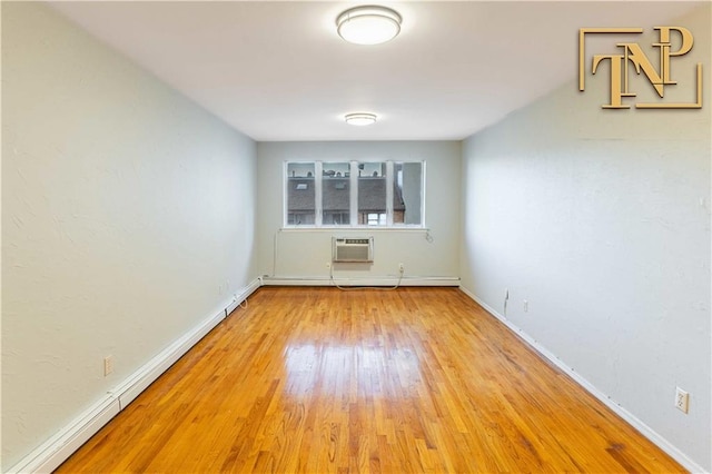 empty room with baseboards, baseboard heating, wood finished floors, and a wall mounted AC