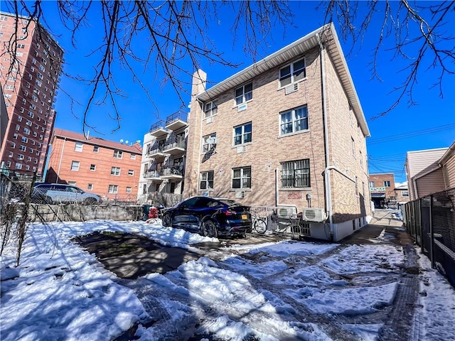 snow covered property featuring cooling unit