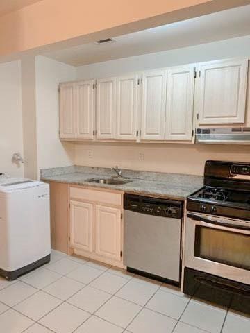 kitchen featuring sink, dishwasher, range hood, range with gas stovetop, and washer / clothes dryer