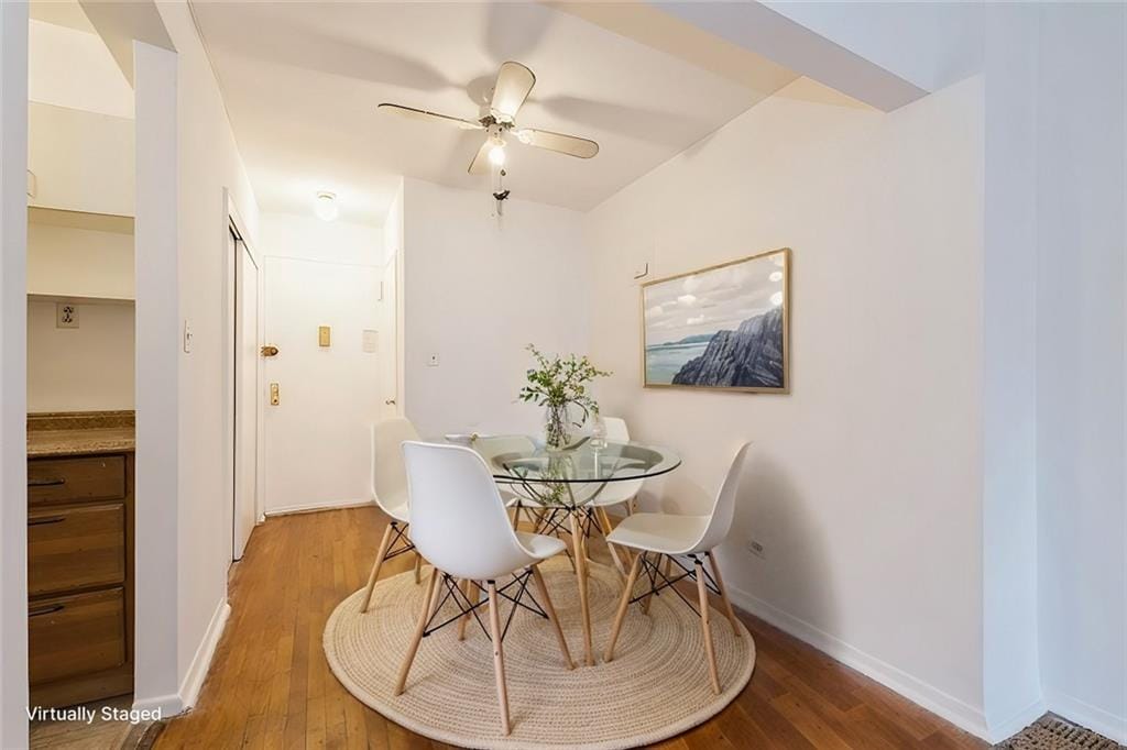 dining room featuring wood-type flooring and ceiling fan