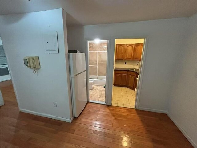 kitchen featuring white fridge and light hardwood / wood-style flooring