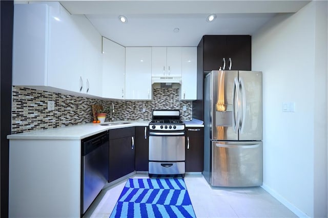 kitchen with sink, decorative backsplash, stainless steel appliances, and white cabinets