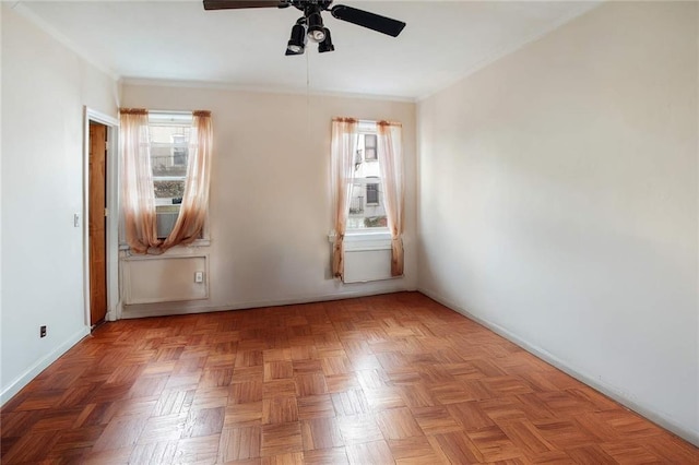 unfurnished room featuring ceiling fan and crown molding