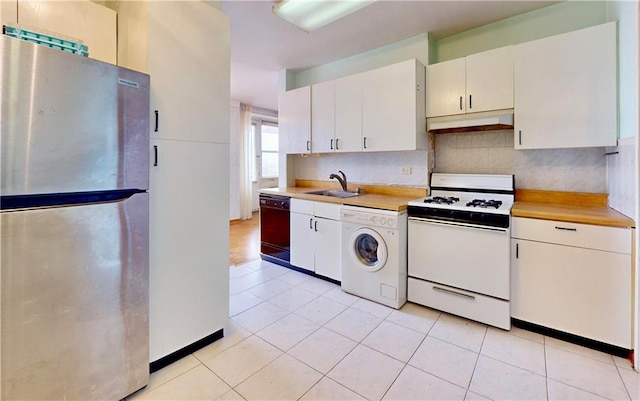 kitchen with washer / dryer, sink, white range with gas stovetop, stainless steel fridge, and black dishwasher