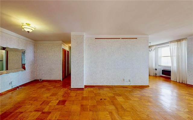 unfurnished room featuring ornamental molding and light parquet flooring